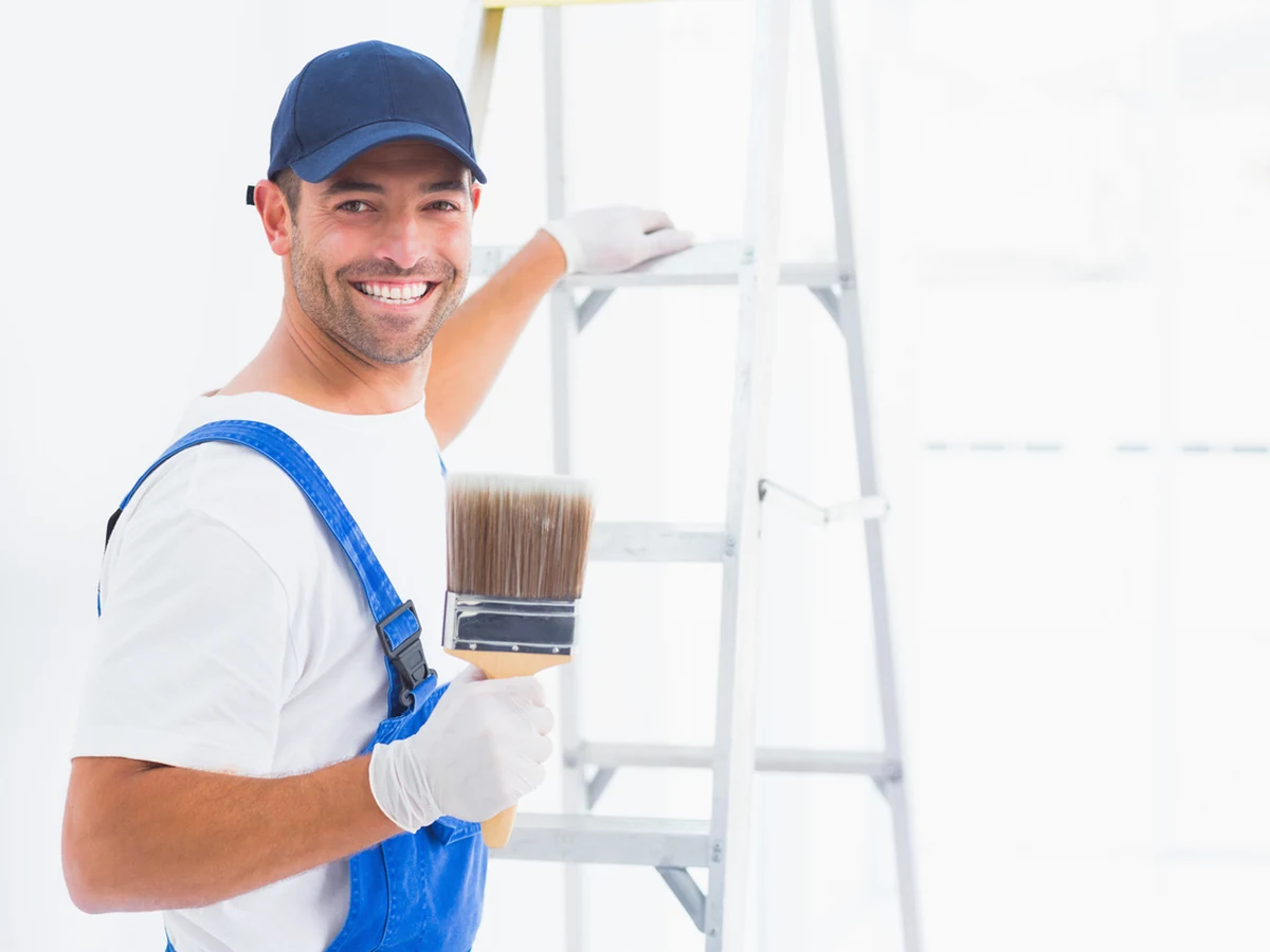 House Painting - Painting Decorating Smiling Painter Holding