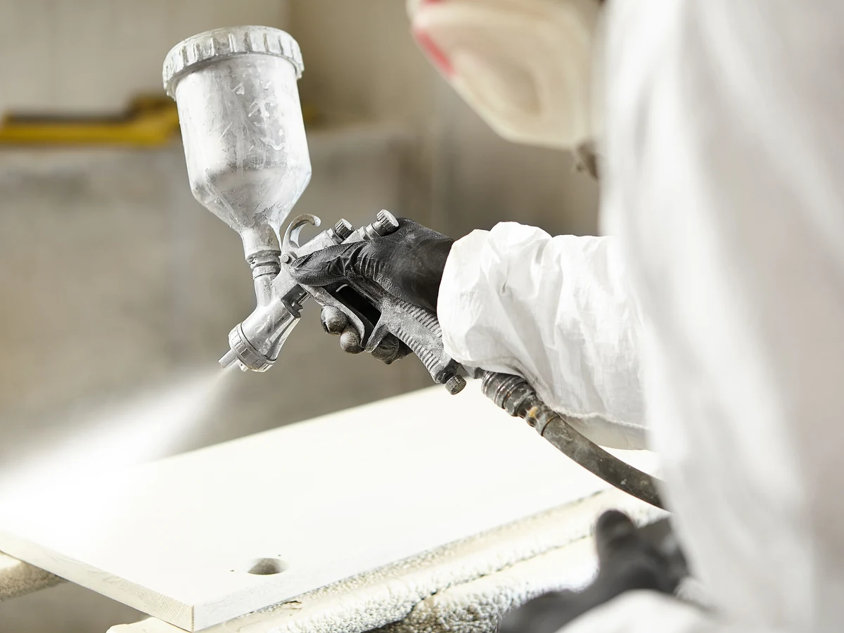 Surrey Decorators painter in white suit working on a Cobham property