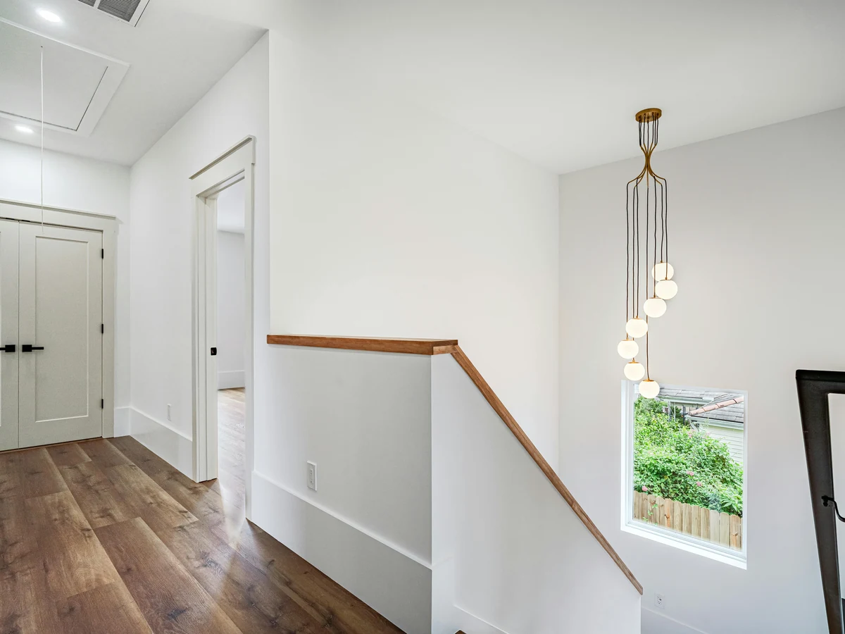 staircase-painting-modern-landing-white-surrey-decorators Staircase painting in Surrey by Surrey Decorators, modern white landing with clean painted spindles